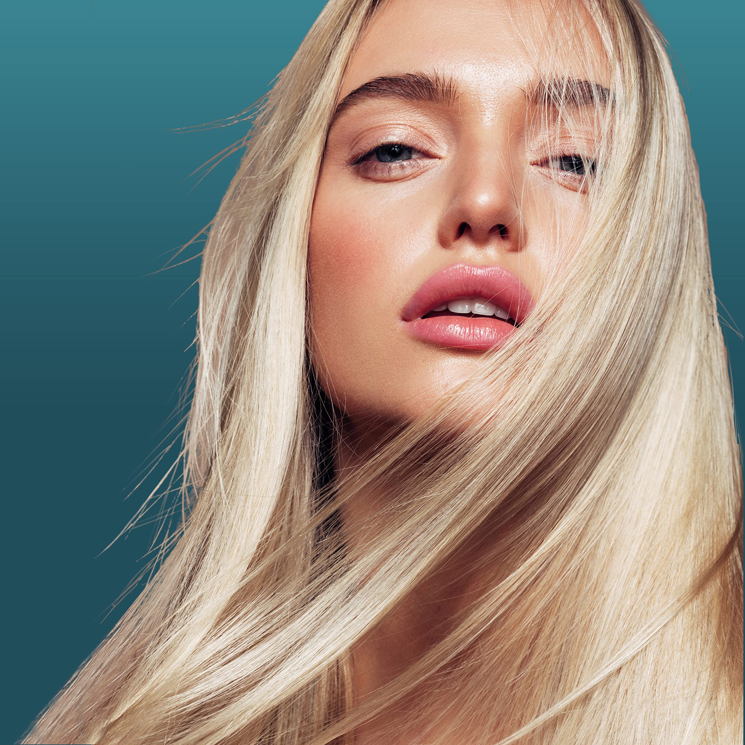 Nexxus Ultralight Smooth Serum application on hair close-up showing smoothing texture