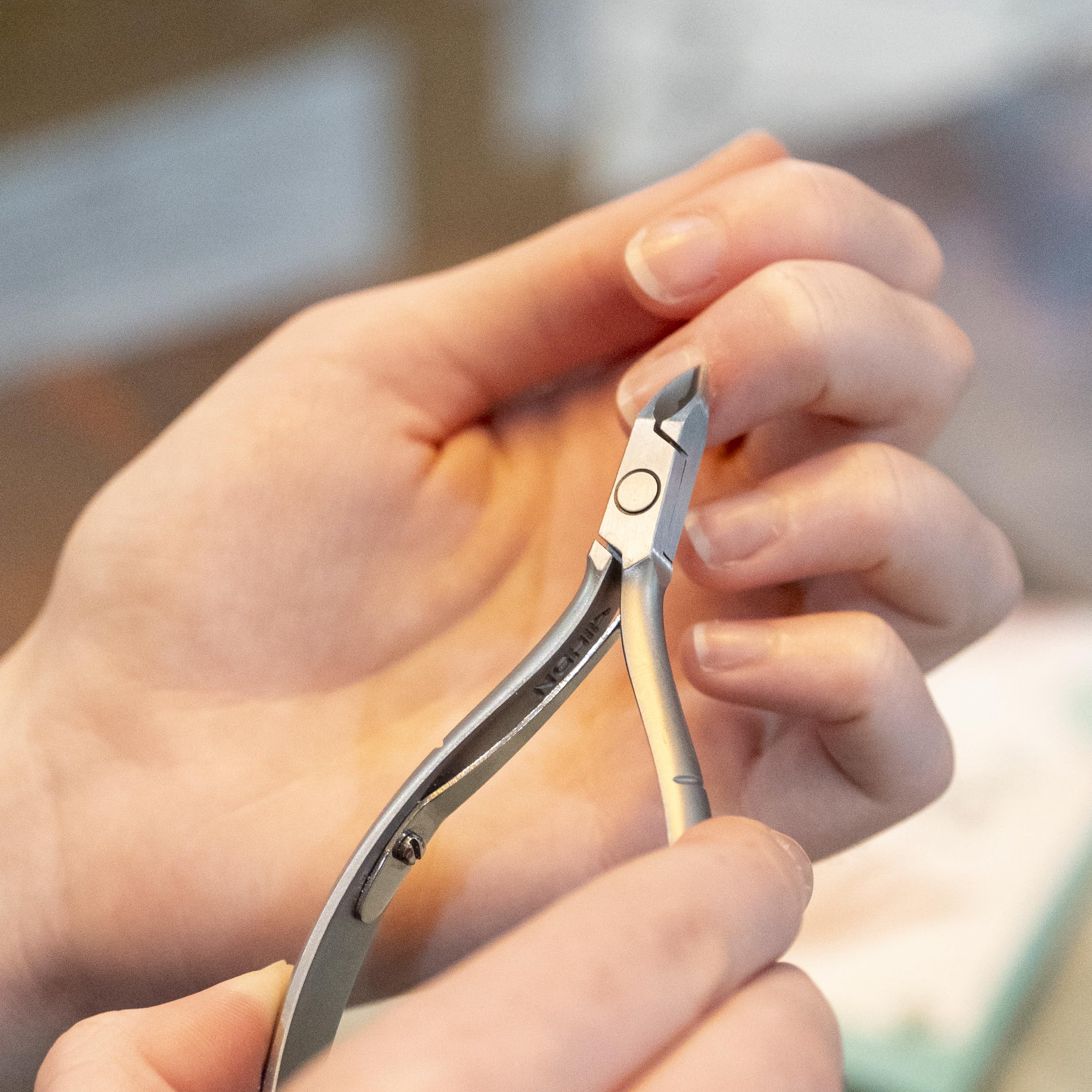 Nghia cuticle nipper D-04 ergonomic handle closeup shows comfortable grip for all hand sizes.