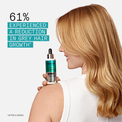 NIOXIN conditioner being dispensed for detangling and strength