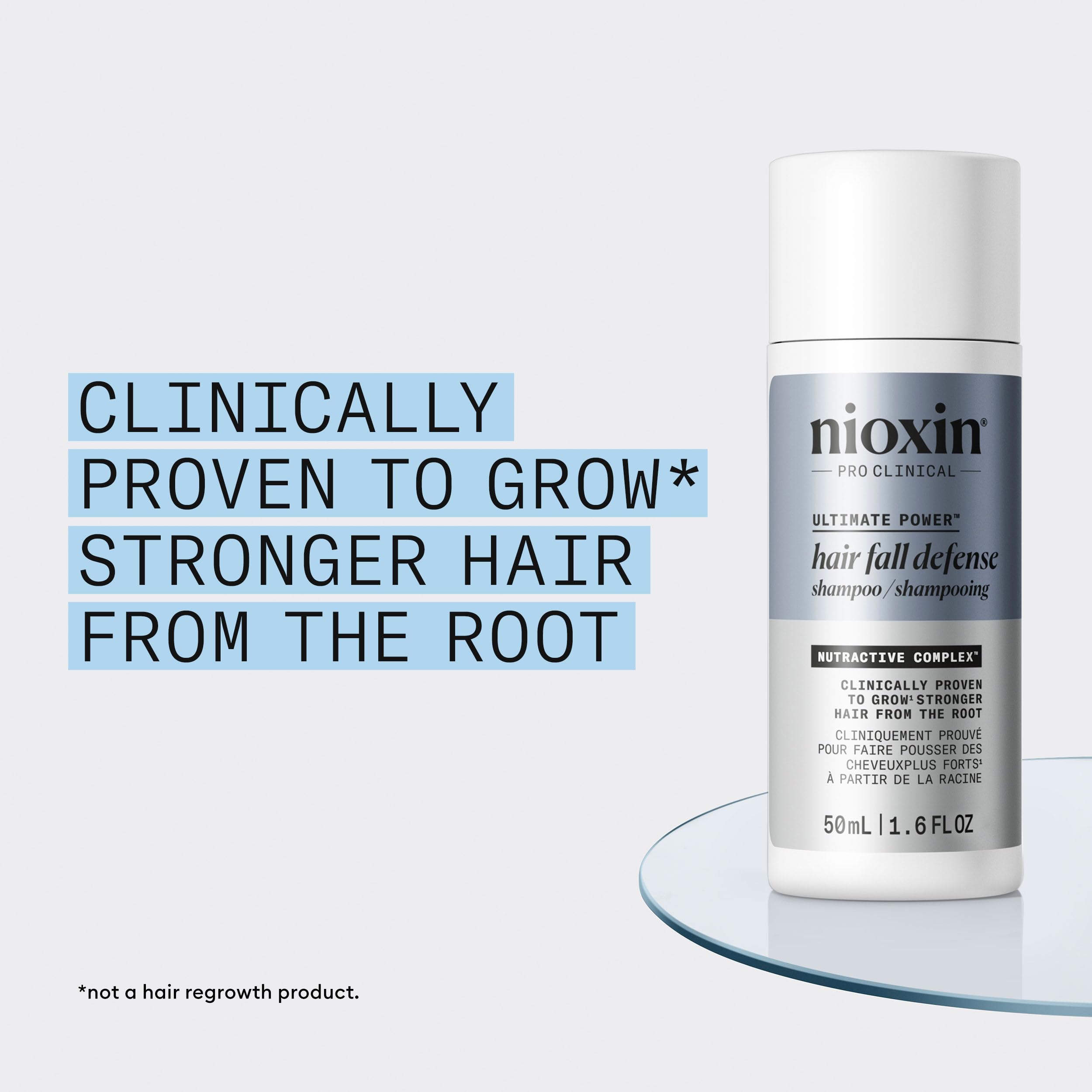 Hand holding NIOXIN 50mL bottle to show compact travel-friendly size benefit