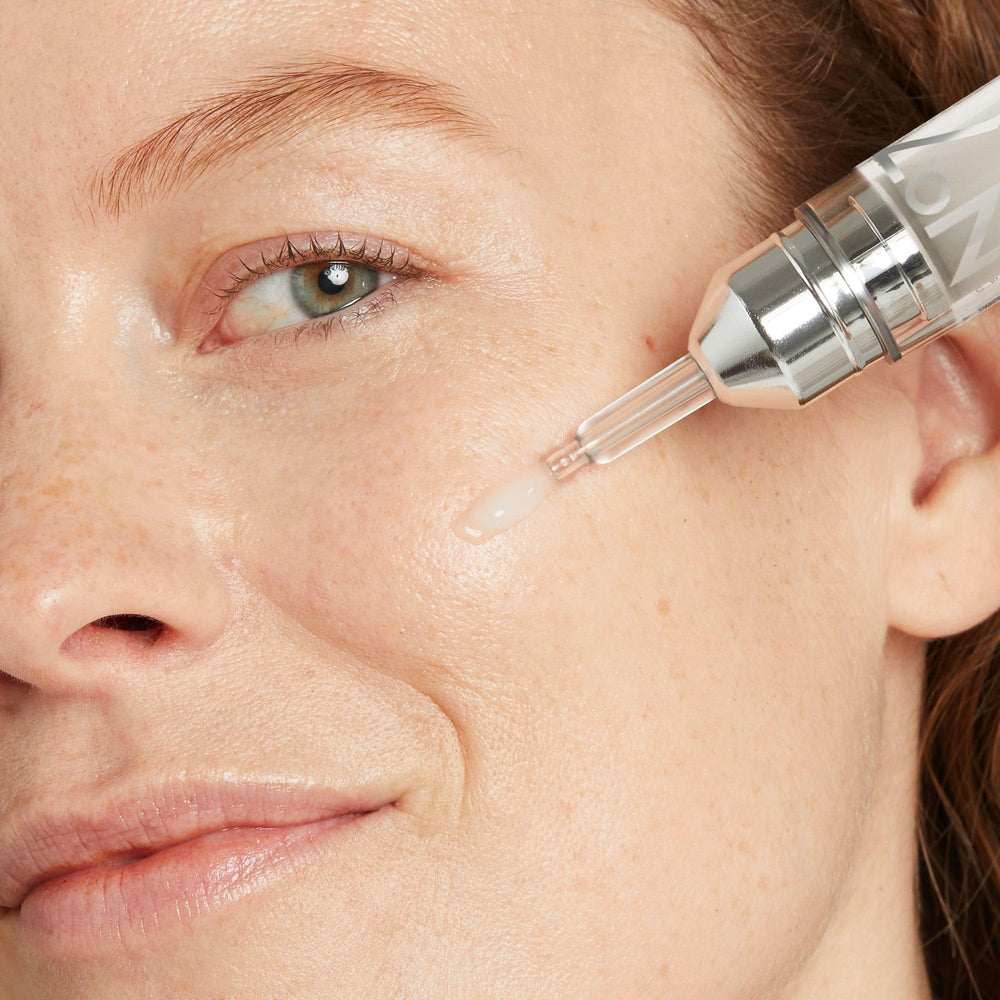 No7 Laboratories Line Correcting Booster Serum applied to forehead wrinkles for smoother appearance.