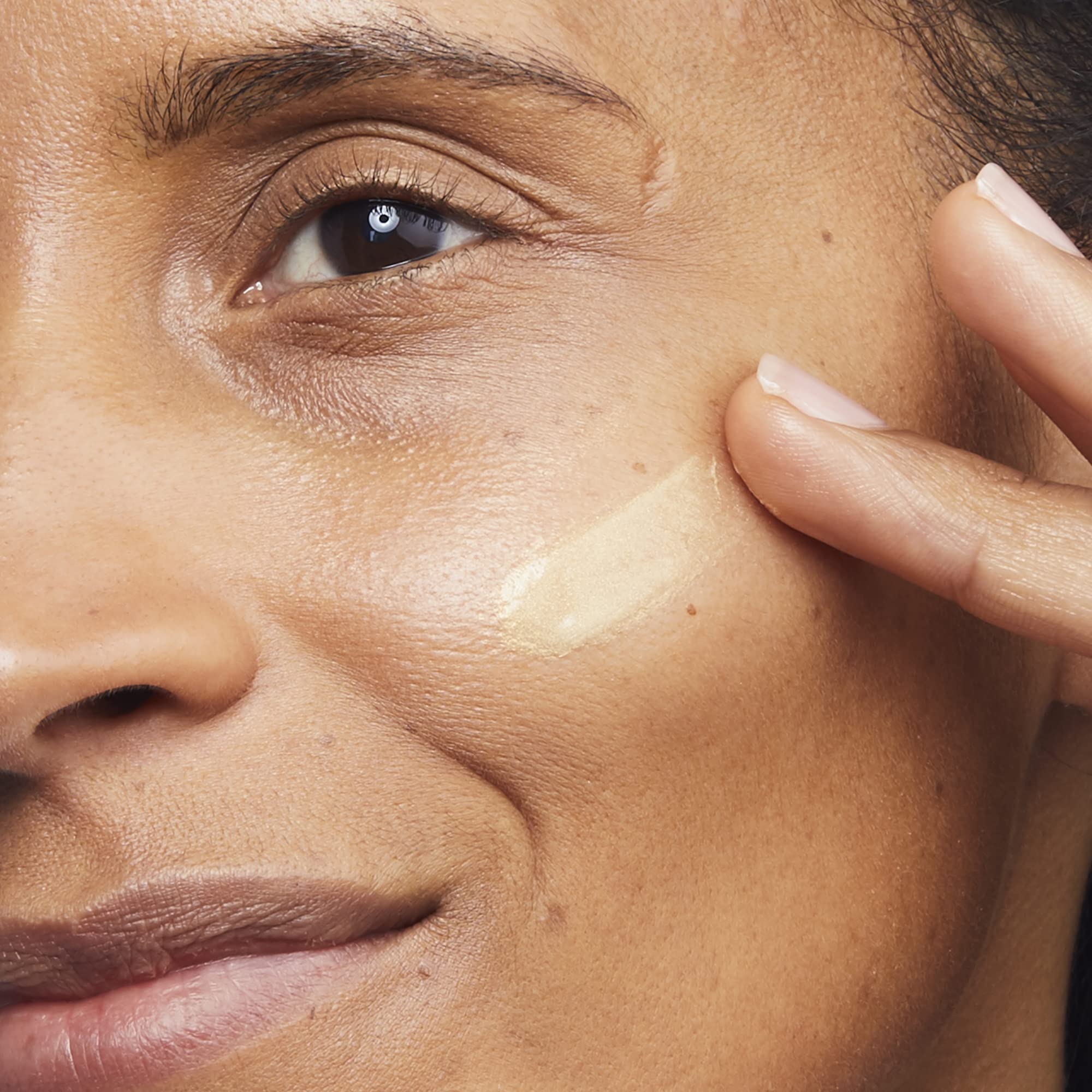 No7 Lift and Luminate Primer on skin showing luminous glow and even texture