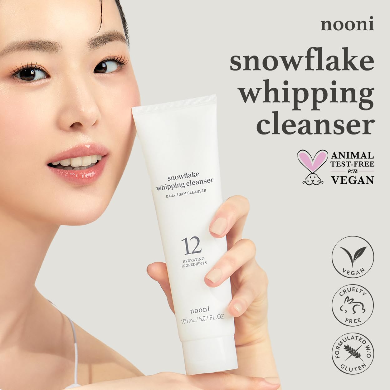 NOONI Snowflake Whipping Cleanser bottle pouring a light, fluffy foam.