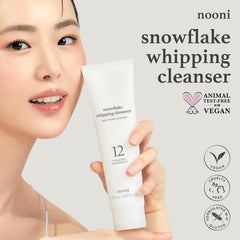 NOONI Snowflake Whipping Cleanser bottle pouring a light, fluffy foam.