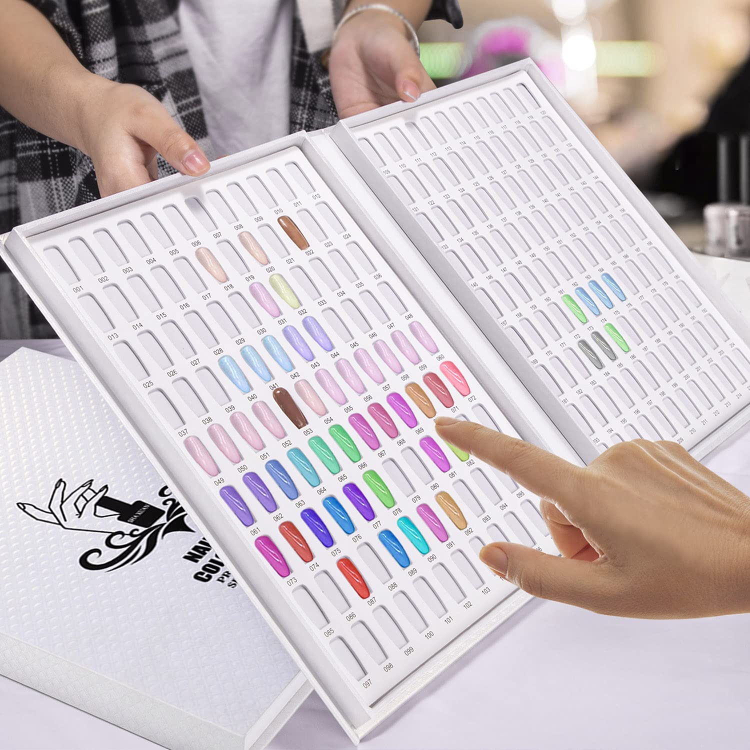 Noverlife Professional 216 Nail Colors Chart open spread showing color comparisons for clients.