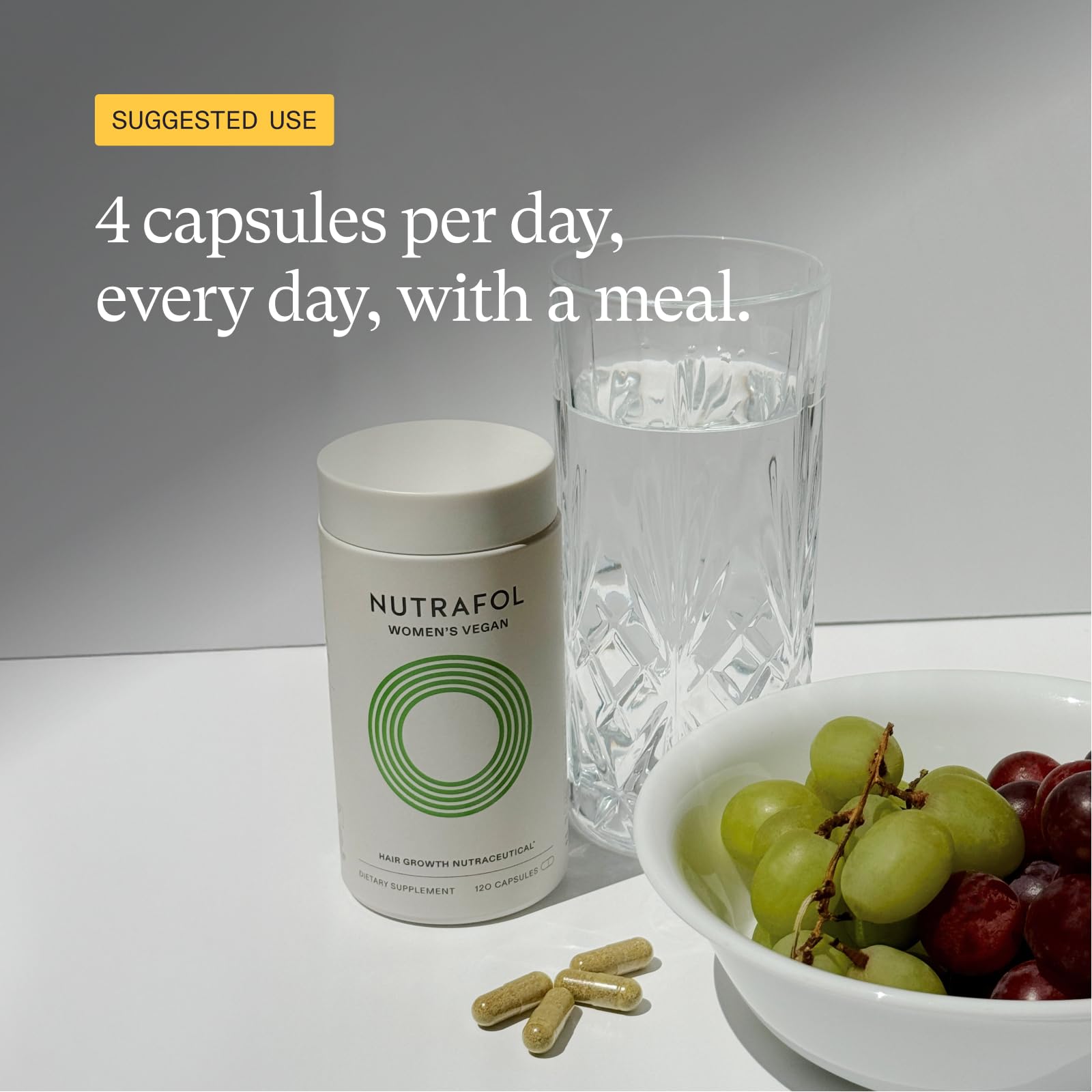 Woman holding Nutrafol bottle in lifestyle setting boosting hair confidence