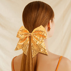 Oaooleer teen girl cheer bow on head demonstrates secure elastic fit for active cheer.