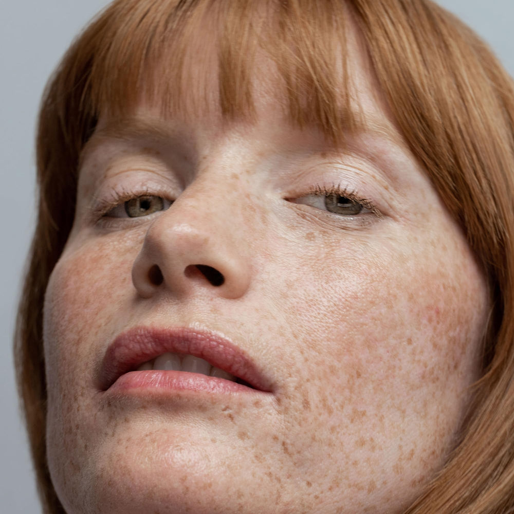 Obagi Sun Shield tinted sunscreen applied on skin showing invisible finish under makeup.