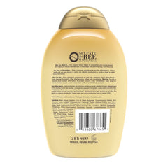 OGX Anti-Hair Fall label close-up highlights caffeine and coconut oil ingredients for strengthening routines.