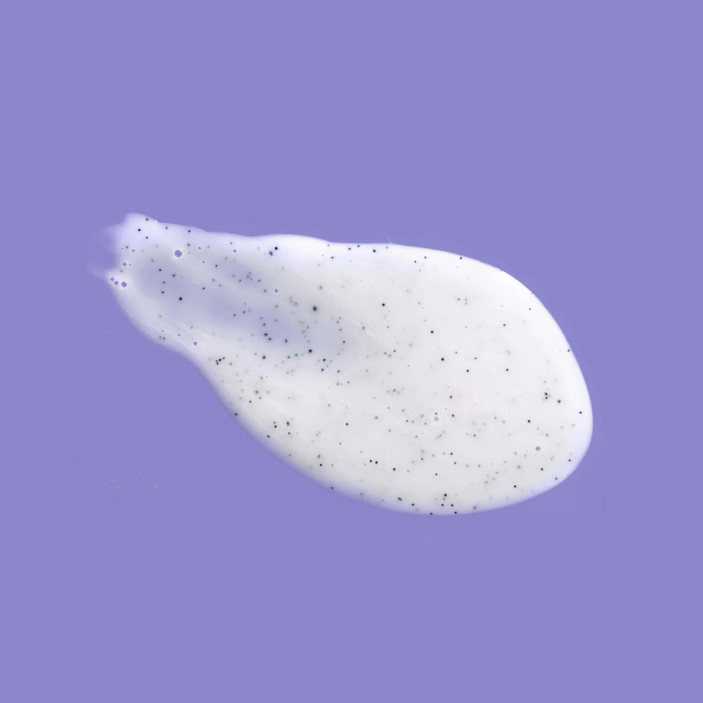 OGX Calming Amethyst Lavender bottle with lavender flowers for aromatherapy-inspired shower.