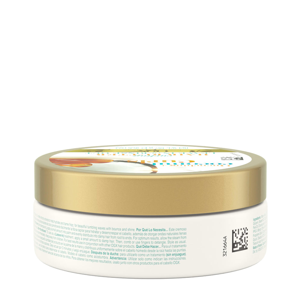 OGX Quenching Coconut Curls Butter tub beside a comb for quick styling boost.