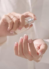 Ohora nails on hand with crisp white N Essential French tips and glossy finish