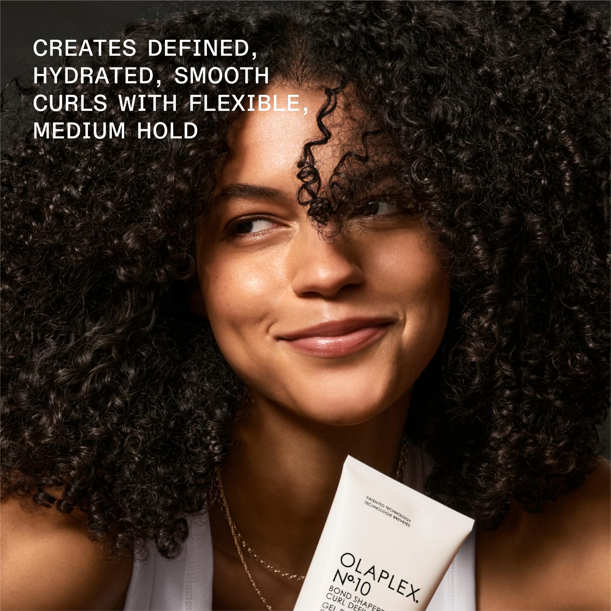 Olaplex Nº.10 being applied to curls to enhance definition and detangle