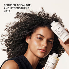 Olaplex Nº.5 bottle placed by shower showing convenience and routine-friendly benefit