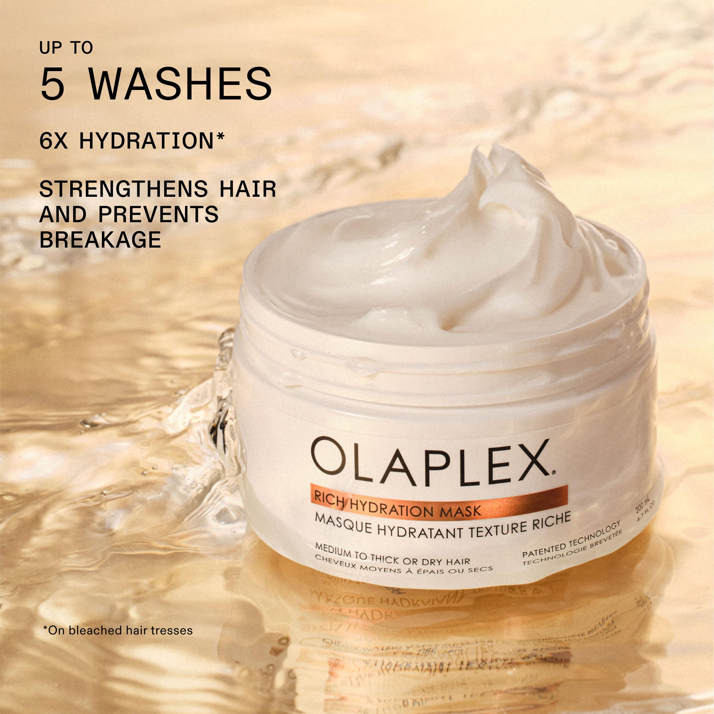 Olaplex being applied to damp hair demonstrating frizz control