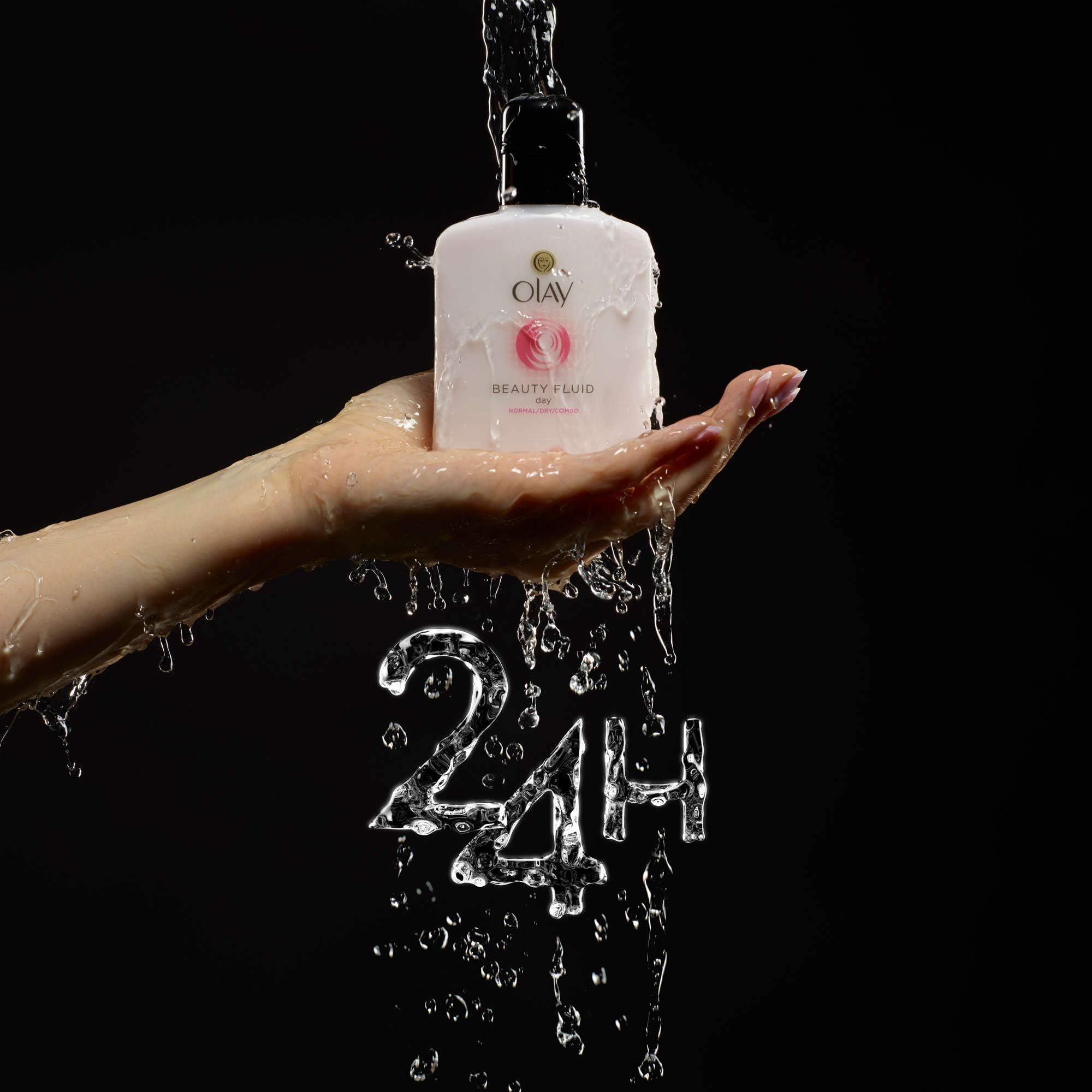 Olay Beauty Fluid Regular 100ml in hand demonstrates light moisturizing feel