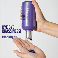 Oligo Professionnel Blacklight Blue Conditioner bottle pouring for hydrating blonde care.
