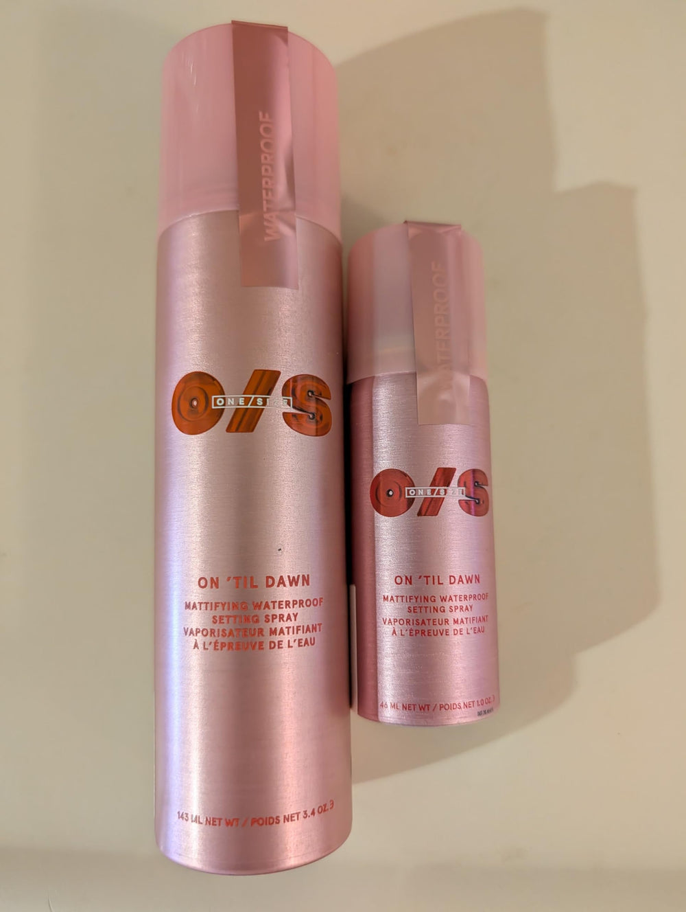 Fine mist from One Size setting spray shows quick-dry, transfer-resistant hold.