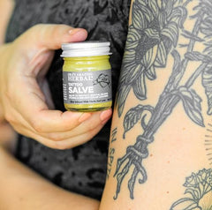 Applying Ora's Tattoo Salve on a fresh tattoo helps soothe itch and moisturize