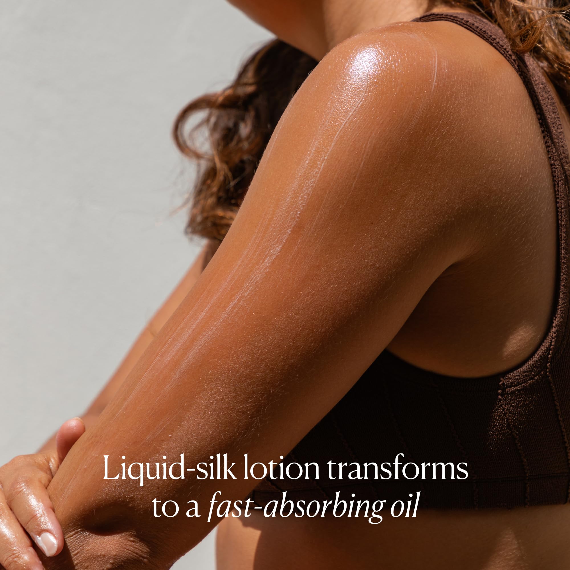 OSEA coconut oil texture on fingers suggesting smooth, velvety skin after application.