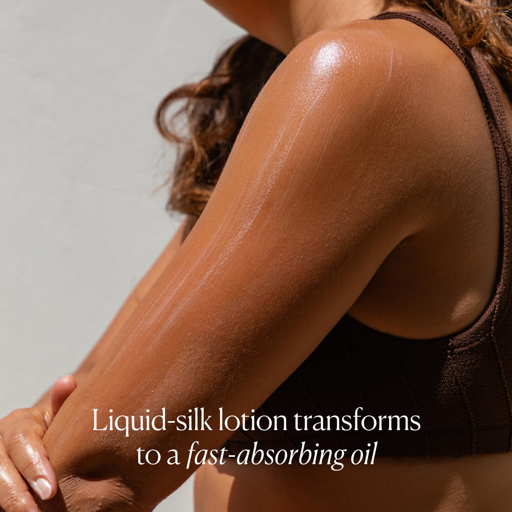 OSEA coconut oil texture on fingers suggesting smooth, velvety skin after application.