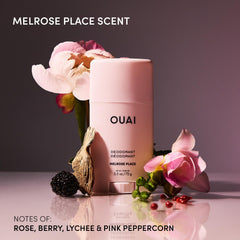 OUAI aluminum-free deodorant application close-up showing clear swipe-on formula