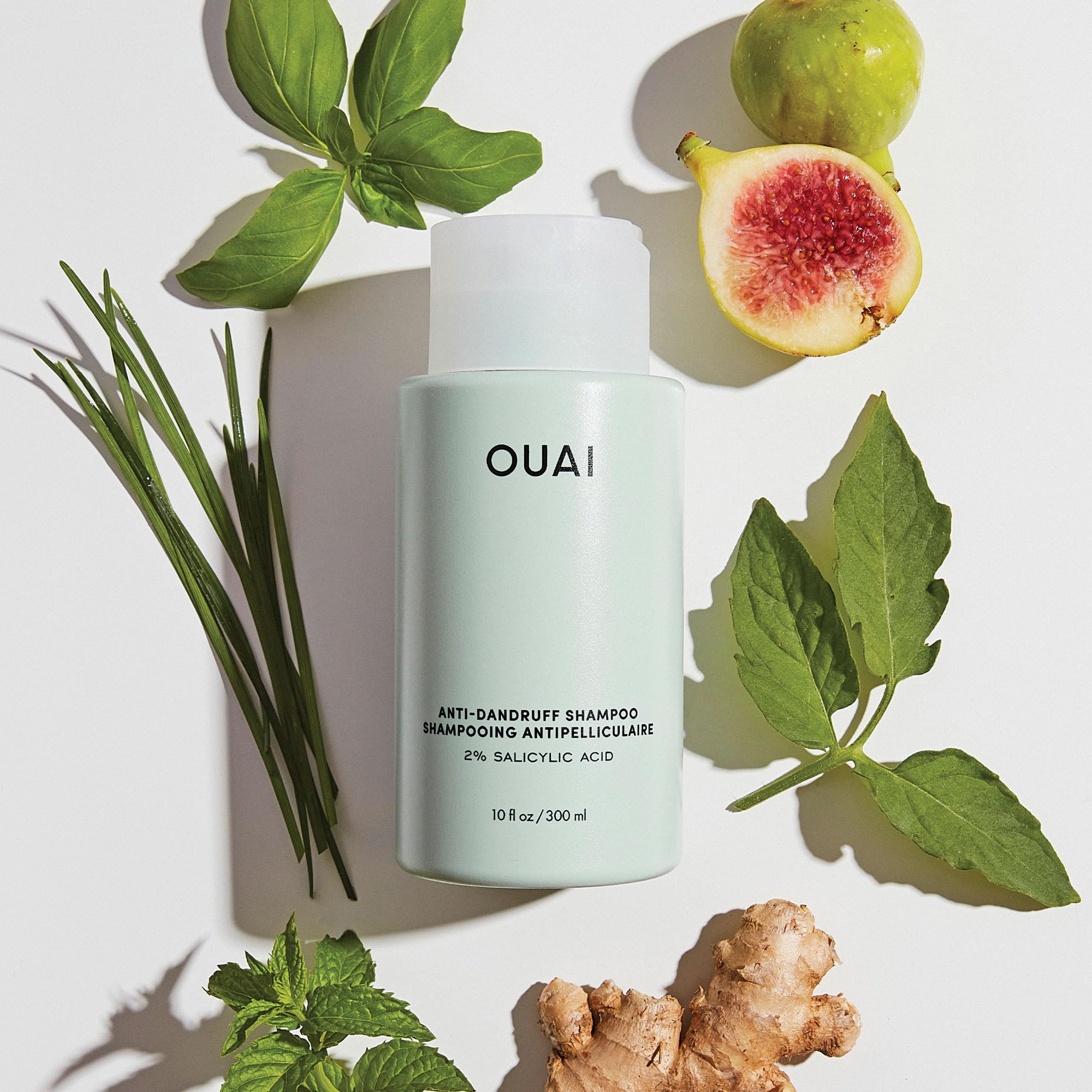 Applying OUAI shampoo to wet hair for cleansing routine
