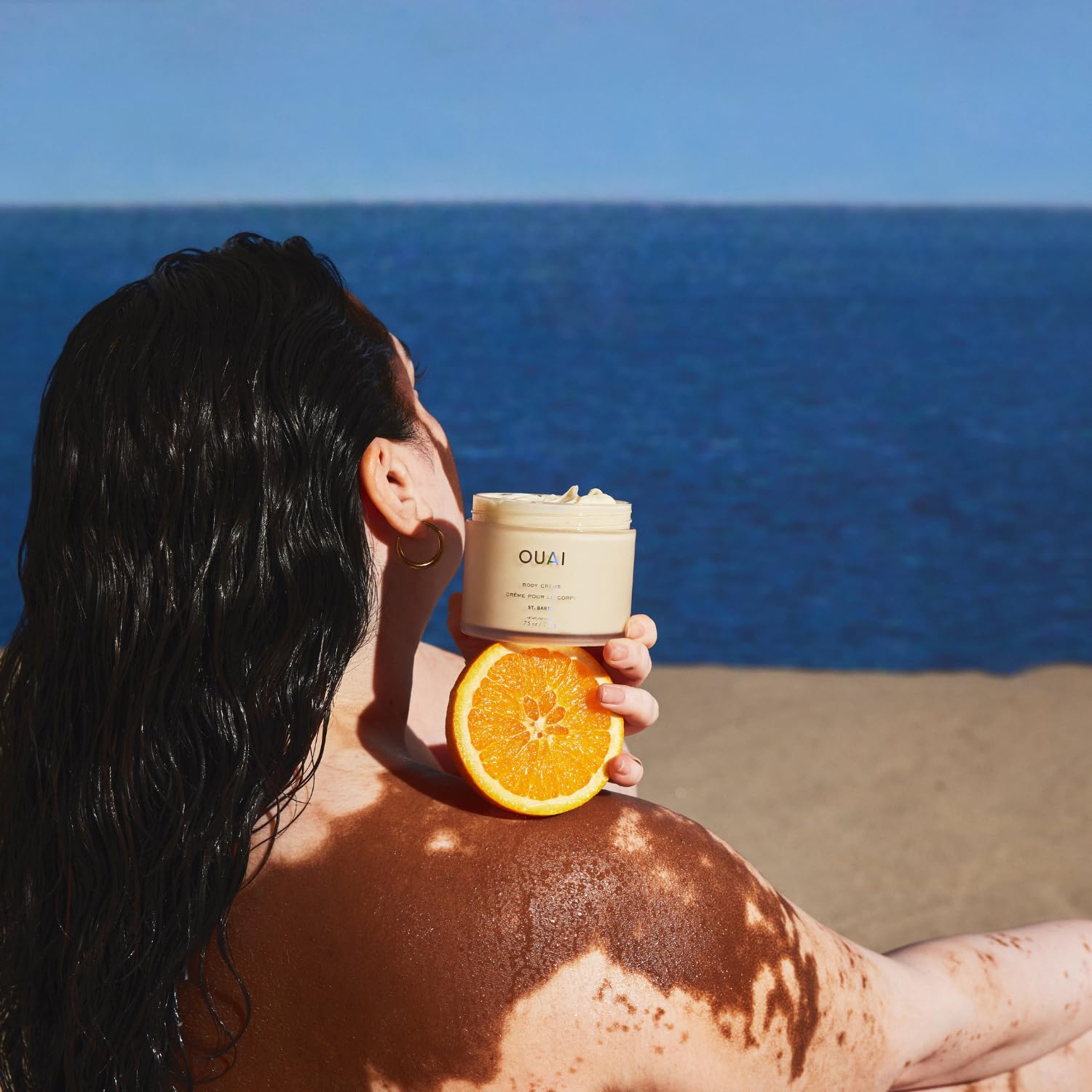 OUAI Body Cream St. Barts texture close-up highlights lightweight, velvety skin feel.