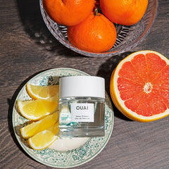 OUAI Dean Street bottle with apricot hints for daytime elegance.