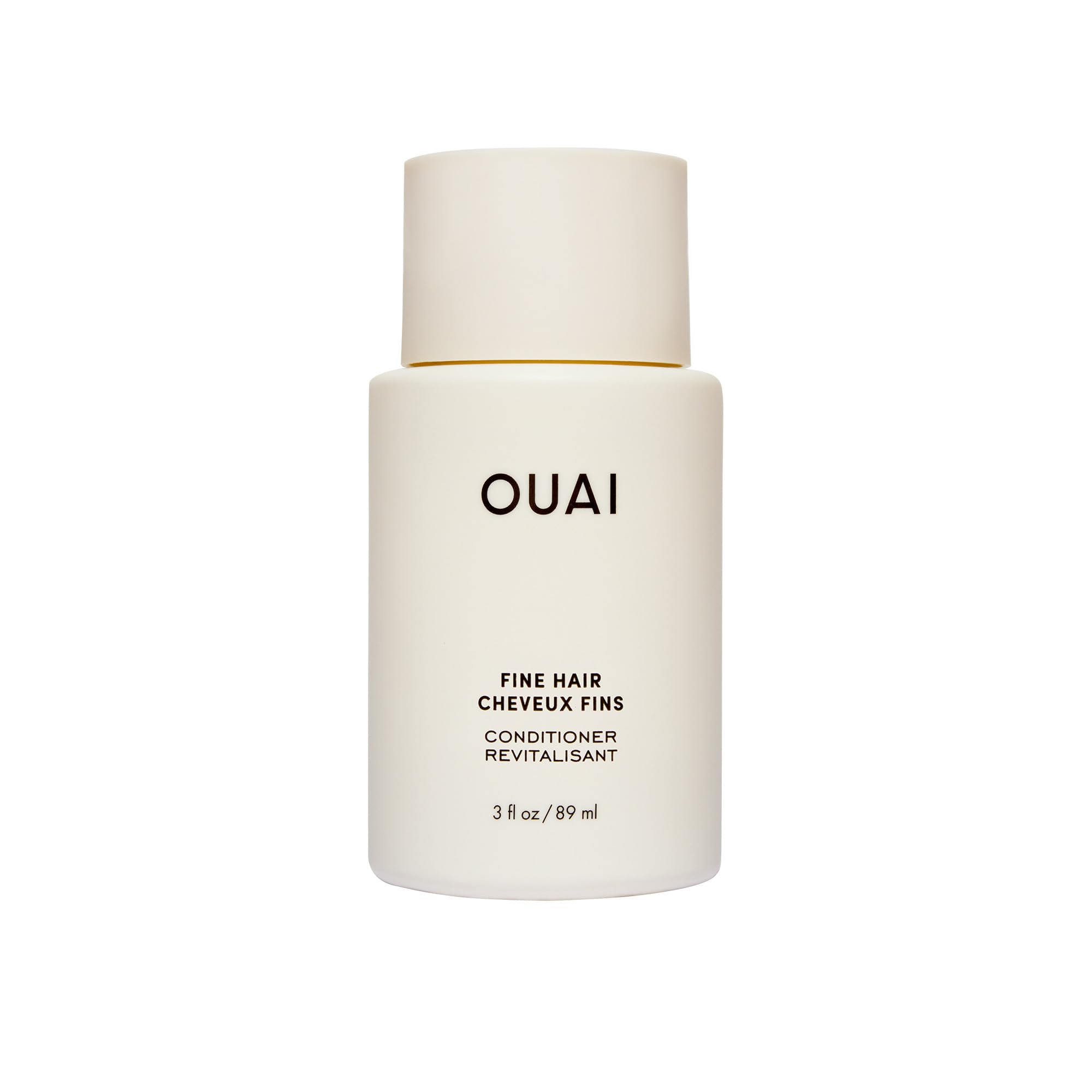 OUAI fine hair conditioner travel-size bottle closeup showing lightweight hydration