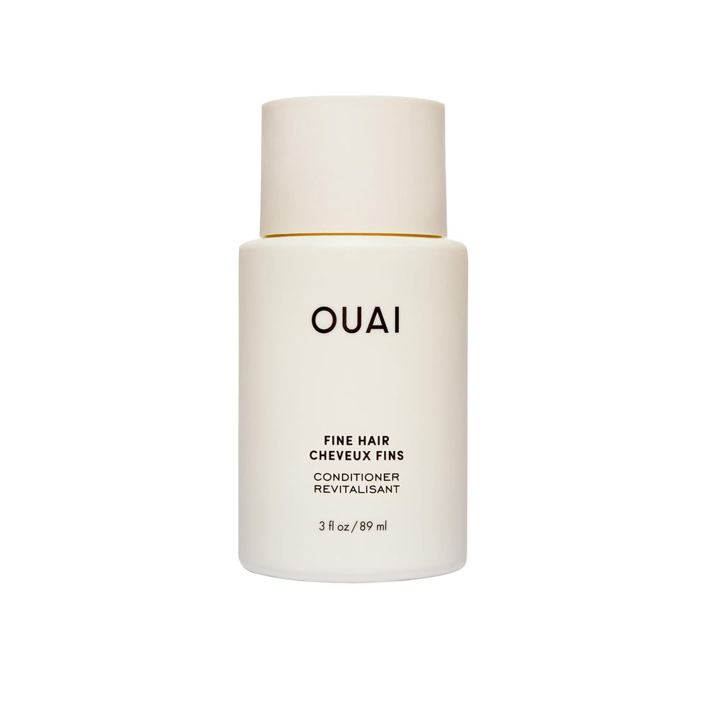 OUAI fine hair conditioner travel-size bottle closeup showing lightweight hydration
