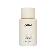 OUAI fine hair conditioner travel-size bottle closeup showing lightweight hydration