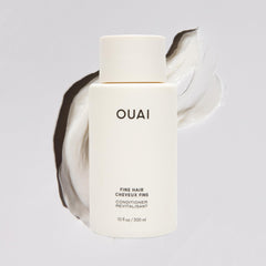 OUAI fine hair conditioner travel-size packaging shown for portable on-the-go styling