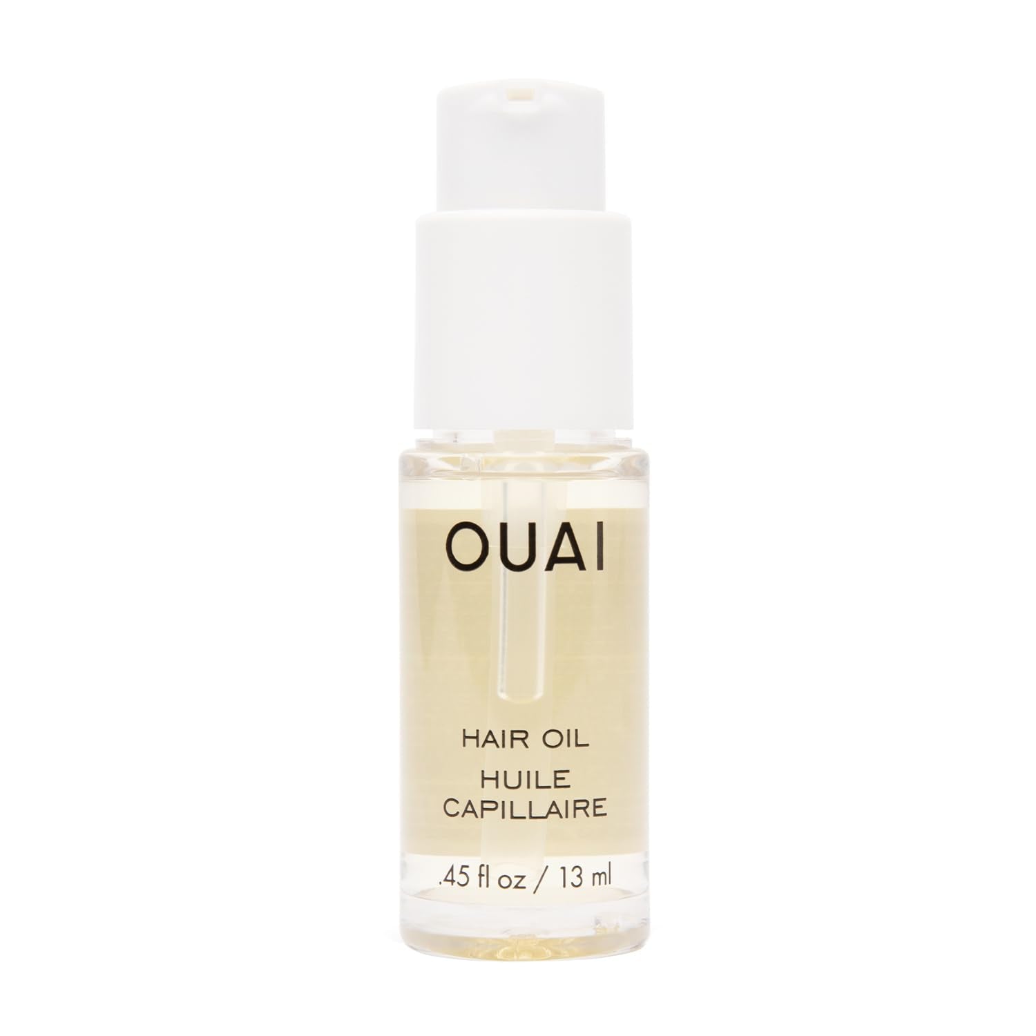 OUAI hair oil travel-size bottle glistens, delivering frizz control and shine on damp hair.