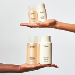 OUAI Medium Shampoo Travel Size hands with lather demonstrates cleansing and moisturizing action.