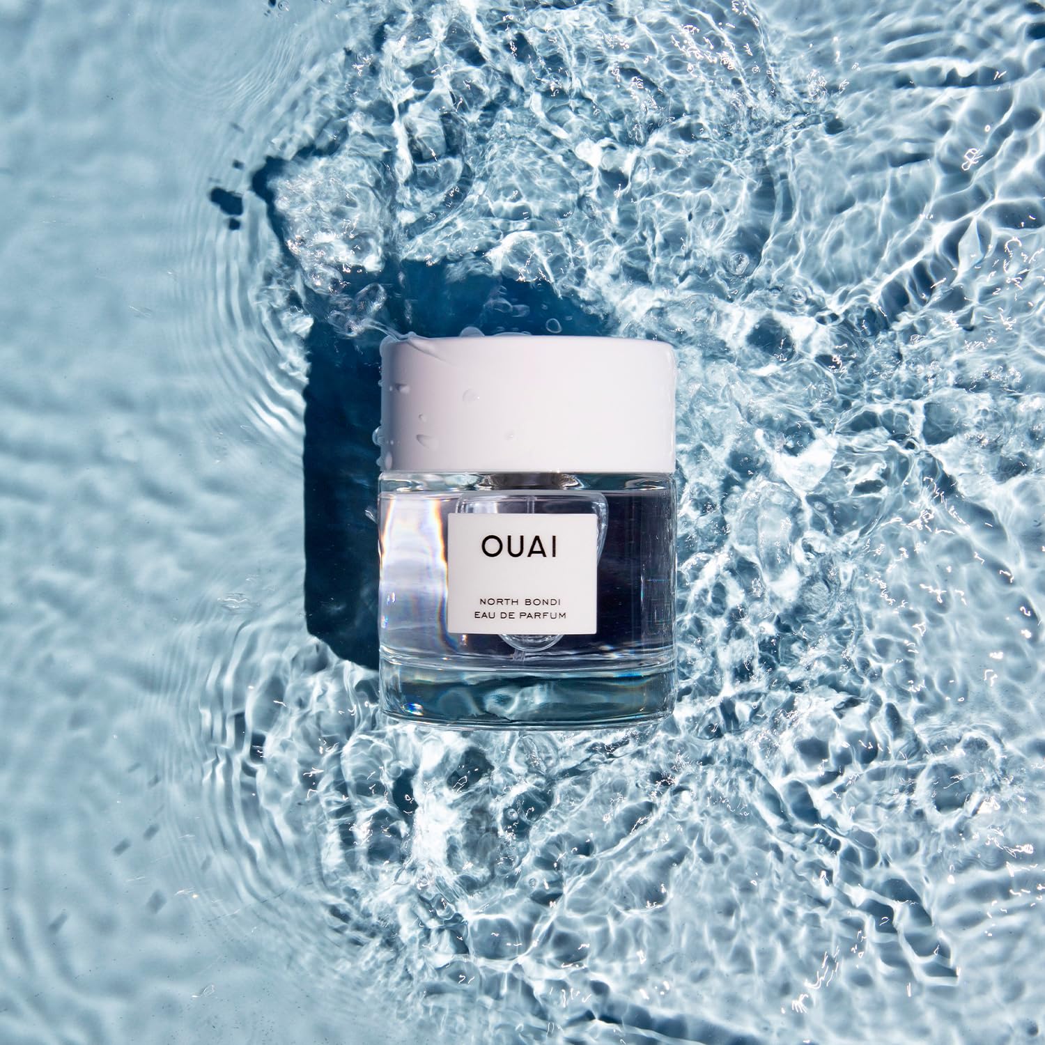OUAI North Bondi bottle beside neck hints at total-body fragrance use.