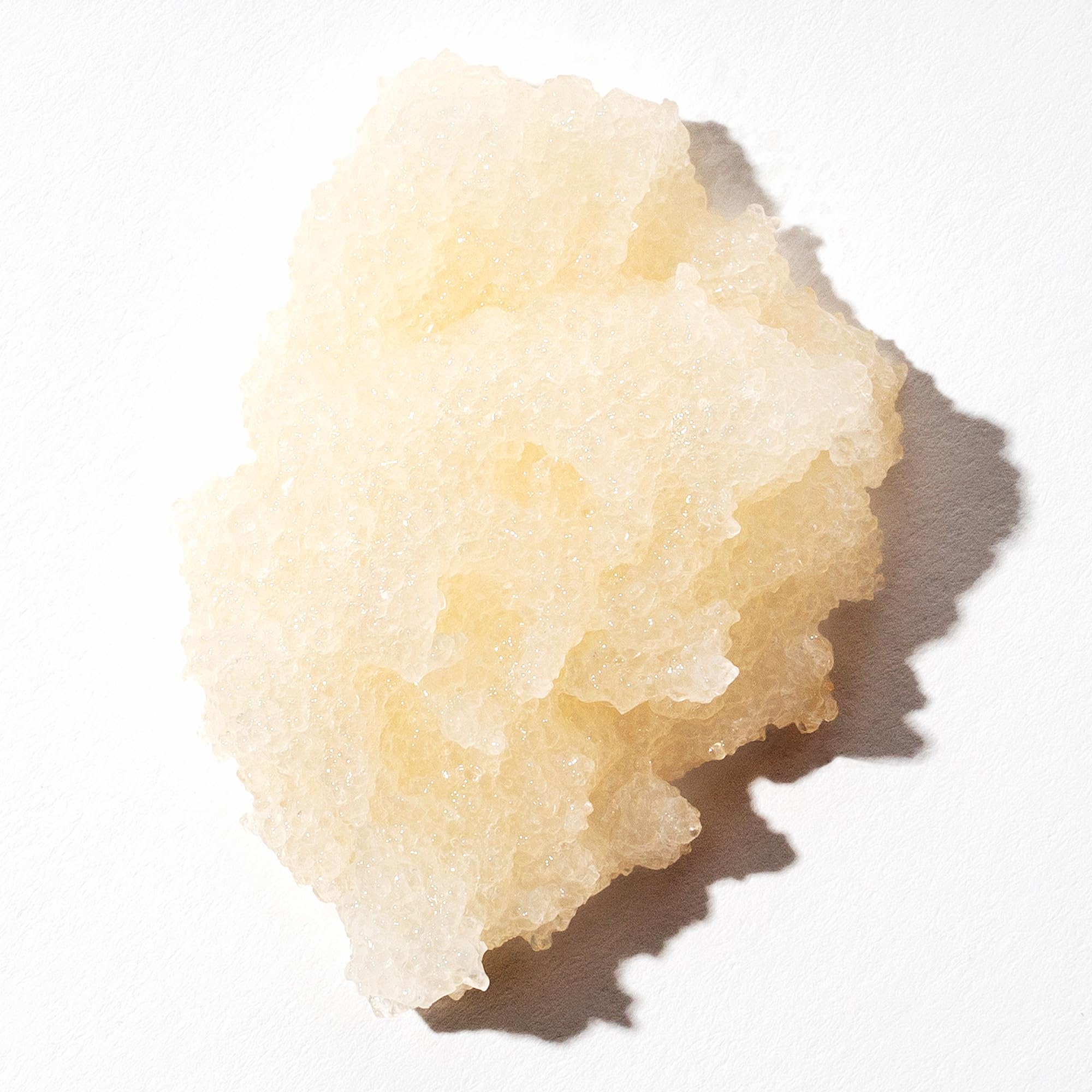 OUAI Scalp & Body Scrub close-up after-use glow on skin.