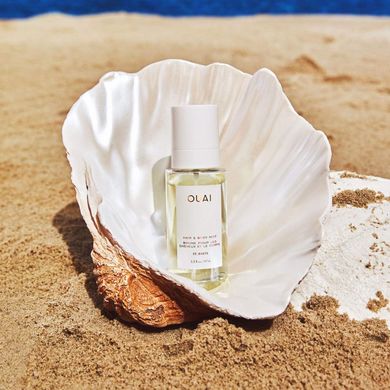 OUAI St. Barts body mist applied on wrists for portable fragrance