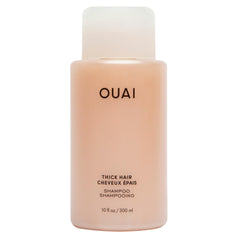 OUAI Thick Shampoo bottle close-up highlighting hydration and frizz control.