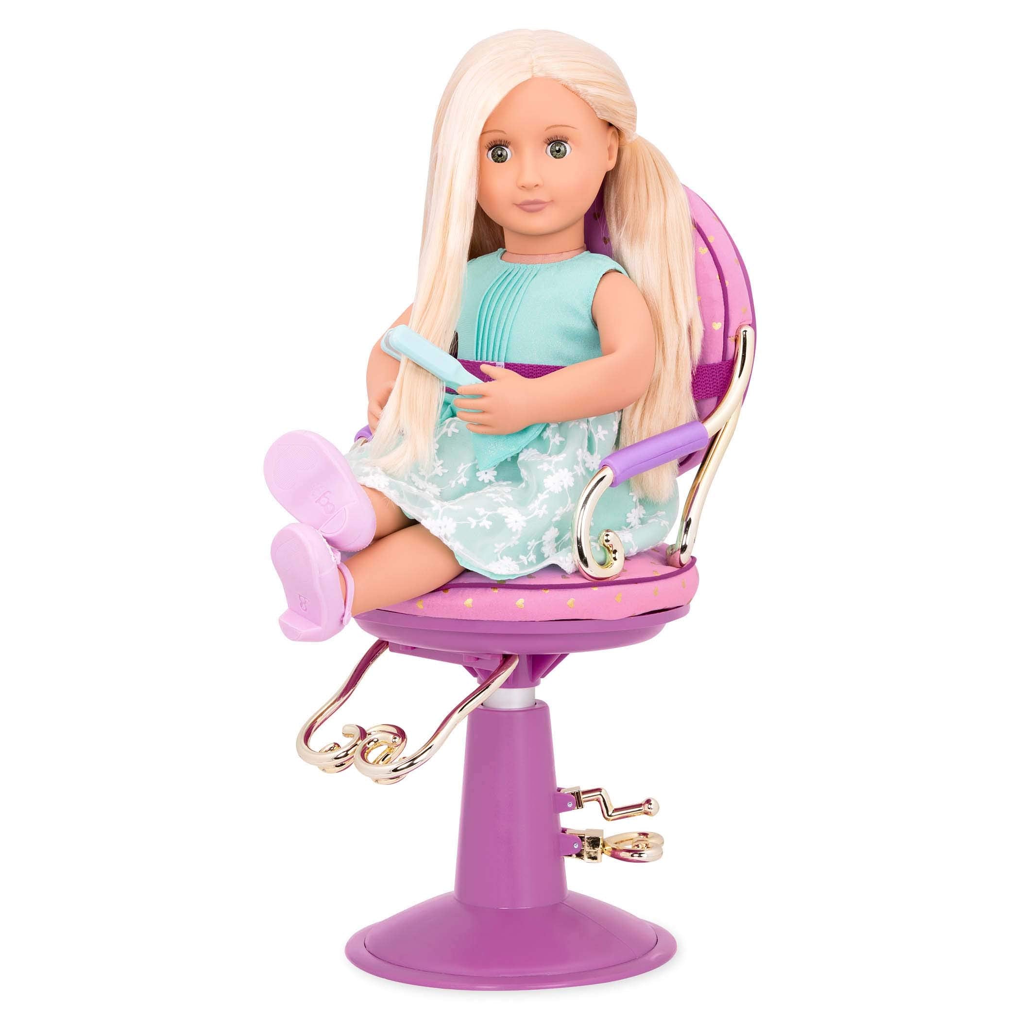 Our Generation pink mirror from the set supports pretend salon consultations.