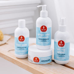 Oyin Handmade Hair Dew applied to curly hair for a refreshing between-wash moment