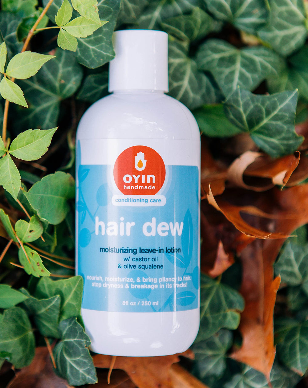 Oyin Handmade Hair Dew on fingertips illustrating hydrating leave-in prep