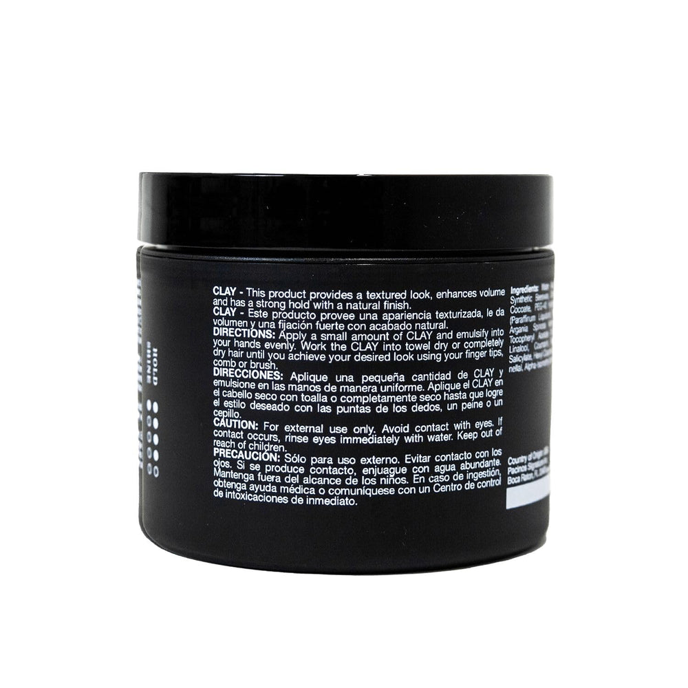Pacinos Signature Line clay hair paste hands applying demonstrates firm hold and textured style.
