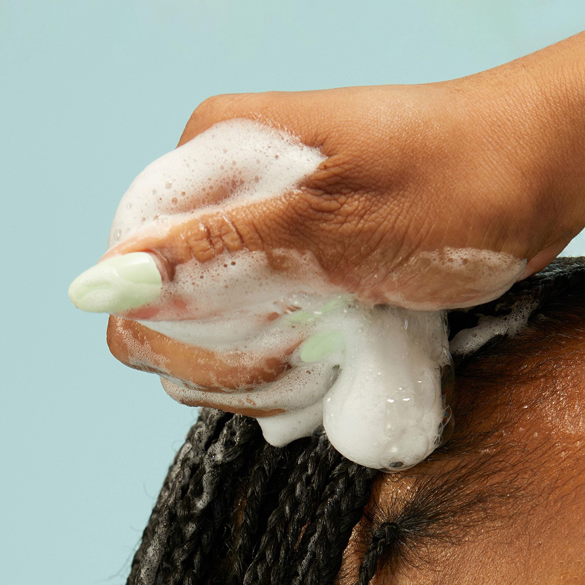 PATTERN Beauty Curl Mousse application in hands shows easy distribution and soft definition.