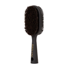 PATTERN Beauty double-sided brush with firm bristles for precise slicking and shaping.