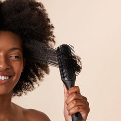 PATTERN Beauty Shower Brush handle closeup shows tapered grip for comfortable styling sessions.
