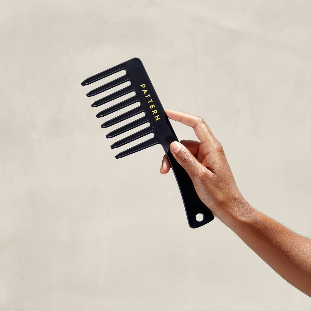 PATTERN Beauty wide-tooth comb working through wet hair for easy sectioning.