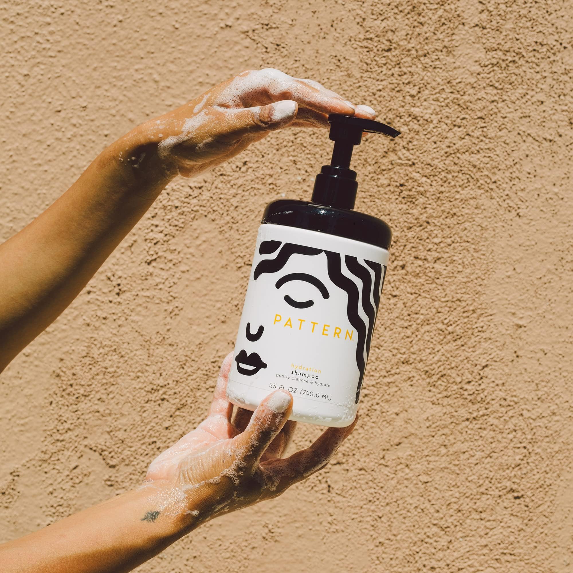 PATTERN Hydration Shampoo biotin molecules indicate supporting healthy-looking curls.