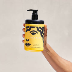 PATTERN Leave-In Conditioner curl texture close-up emphasizes defined waves and moisture.