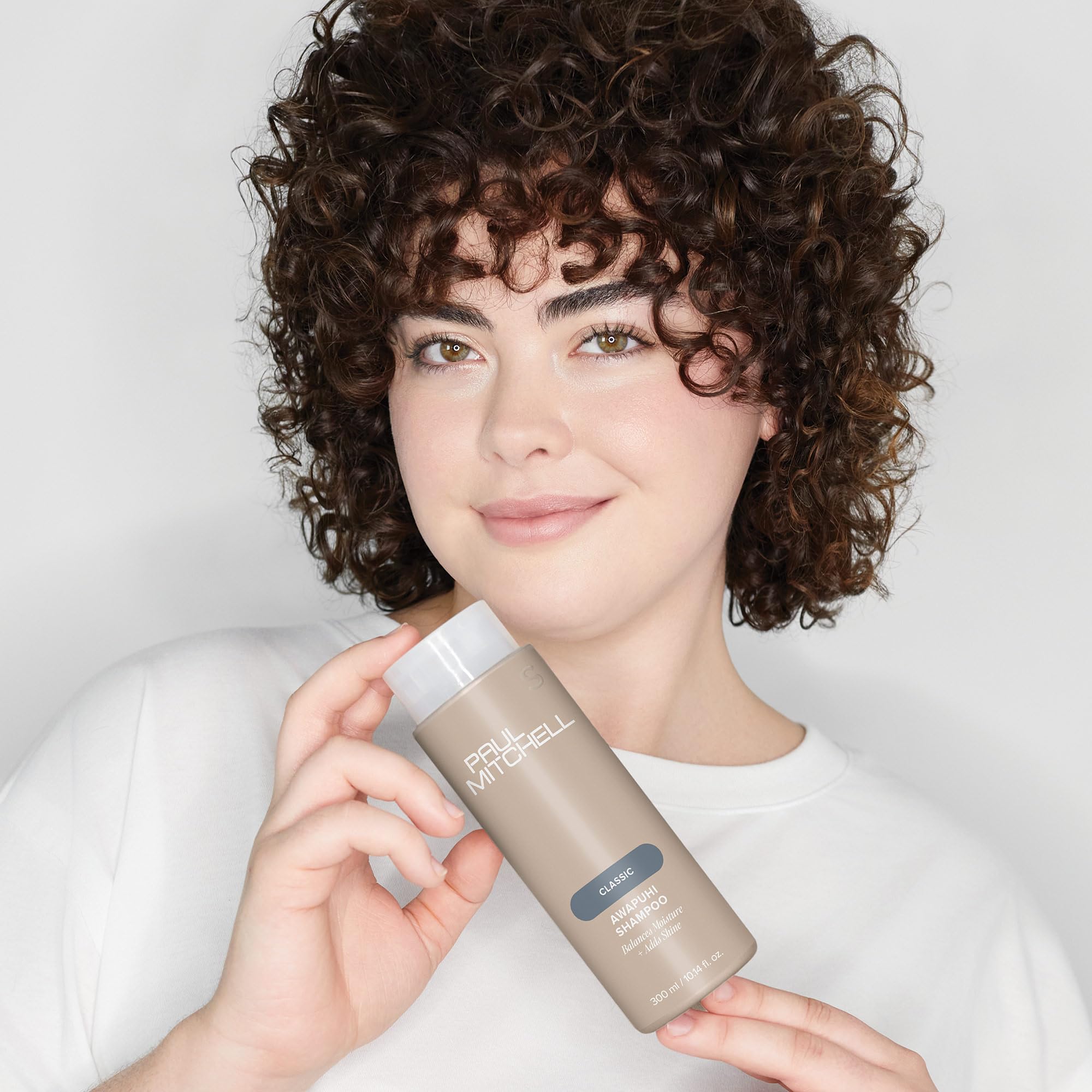 Paul Mitchell Awapuhi Shampoo bottle on sink hints refreshing cucumber-melon scent.
